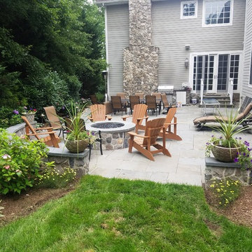 Patio with stone wall and fire pit