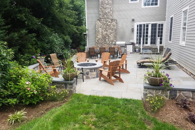 Large traditional backyard patio in New York with a fire feature and no cover.