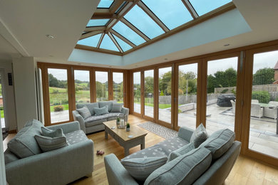 Design ideas for a large contemporary conservatory in Sussex with a glass ceiling.