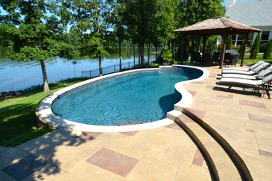 Custom-shaped pool photo in Little Rock
