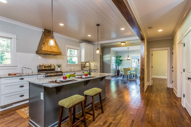 Kitchen - country l-shaped kitchen idea in Atlanta with subway tile backsplash and an island