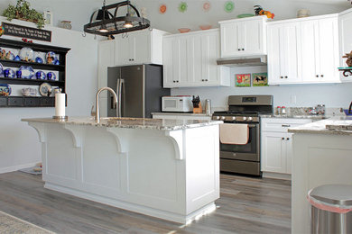 Example of a kitchen design in Other with shaker cabinets, white cabinets and an island