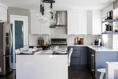 Example of a mid-sized minimalist kitchen design in Calgary with flat-panel cabinets, blue cabinets, quartz countertops, white backsplash, an island and white countertops