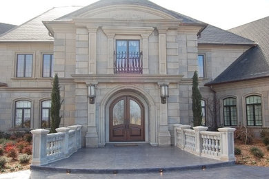 Inspiration for a huge timeless gray two-story exterior home remodel in Other