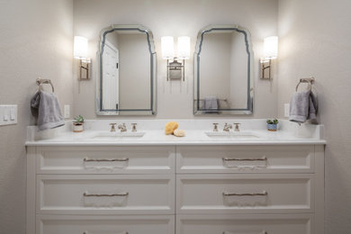 Mid-sized transitional kids' white tile and porcelain tile porcelain tile, gray floor and double-sink walk-in shower photo in Denver with raised-panel cabinets, white cabinets, a two-piece toilet, gray walls, an undermount sink, quartz countertops, a hinged shower door, white countertops, a niche and a built-in vanity