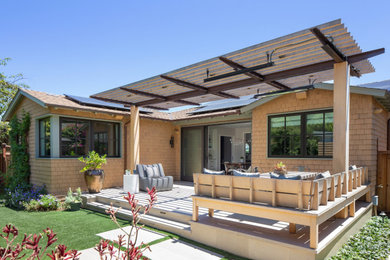 Example of an arts and crafts backyard stone patio design in San Francisco with a pergola