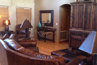 Inspiration for a mid-sized rustic enclosed medium tone wood floor living room remodel in Phoenix with white walls