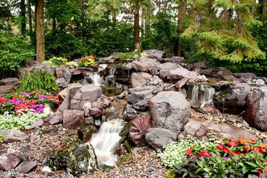 Design ideas for a mid-sized rustic partial sun backyard water fountain landscape in Minneapolis for summer.