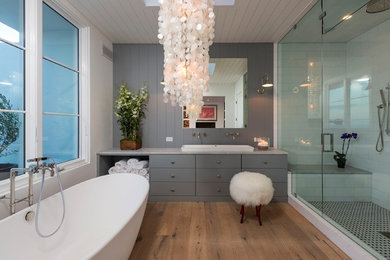 Alcove shower - large transitional master white tile and subway tile medium tone wood floor alcove shower idea in Other with flat-panel cabinets, gray cabinets, white walls, a trough sink and quartz countertops