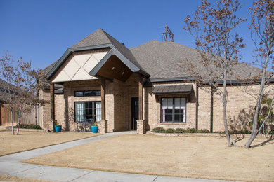 Mid-sized elegant one-story brick exterior home photo in Austin