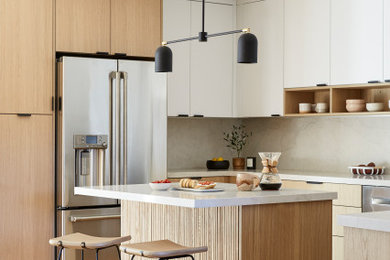 Example of a large danish u-shaped light wood floor and brown floor eat-in kitchen design in San Francisco with a farmhouse sink, flat-panel cabinets, light wood cabinets, quartz countertops, white backsplash, quartz backsplash, stainless steel appliances, an island and white countertops