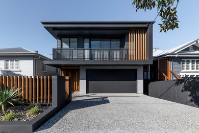 Photo of a contemporary two-storey black house exterior in Brisbane with mixed siding and a flat roof.