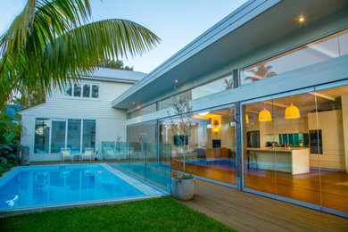 Example of a large minimalist yellow house exterior design in Sydney