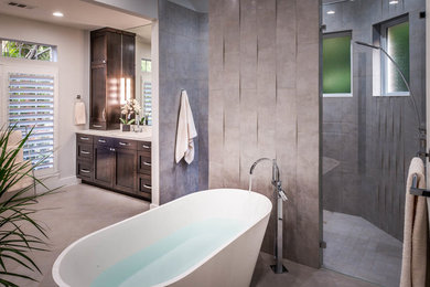 Example of a large minimalist master bathroom design in Houston with shaker cabinets, dark wood cabinets and gray walls