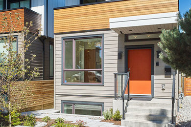 This is an example of a small modern two-storey grey exterior in Vancouver with concrete fiberboard siding.
