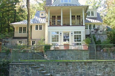 Inspiration for a large traditional three-storey yellow exterior in New York with mixed siding and a clipped gable roof.