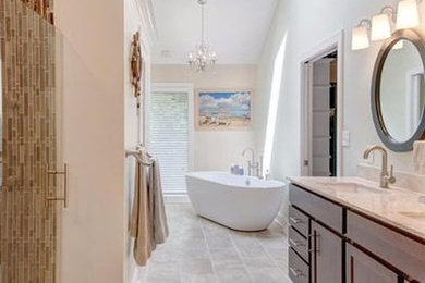Inspiration for a contemporary master beige tile, brown tile and glass tile beige floor freestanding bathtub remodel in Philadelphia with recessed-panel cabinets, medium tone wood cabinets, white walls and an undermount sink
