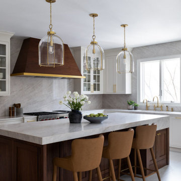 Custom Walnut and White Kitchen Remodel with Marble Slab Backsplash and Brass Ac