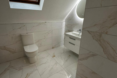 This is an example of a medium sized mediterranean cloakroom in Other with ceramic flooring.