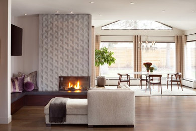 Large contemporary open concept family room in Denver with white walls and a wall-mounted tv.