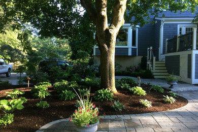 This is an example of a mid-sized traditional side yard garden in Boston with concrete pavers.