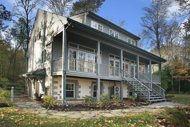 Example of a large country blue three-story wood exterior home design in Philadelphia with a shingle roof