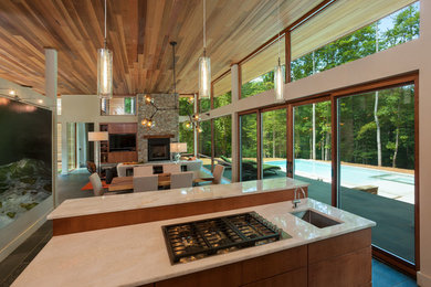 Kitchen - large contemporary slate floor and gray floor kitchen idea in Charlotte with an undermount sink, flat-panel cabinets, medium tone wood cabinets and an island