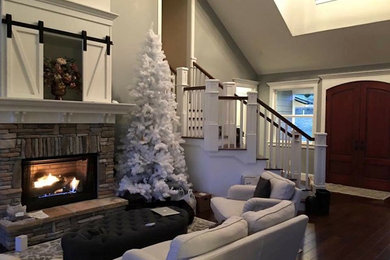 Example of a mid-sized classic open concept dark wood floor living room design in Atlanta with gray walls, a standard fireplace and a stone fireplace