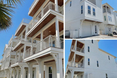 Mid-sized coastal white four-story concrete fiberboard house exterior idea in Miami with a metal roof