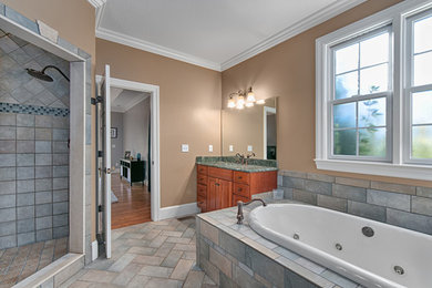 Inspiration for a large timeless master multicolored tile and subway tile ceramic tile bathroom remodel in Other with an integrated sink, flat-panel cabinets, medium tone wood cabinets, granite countertops and beige walls