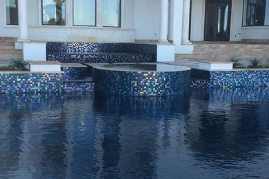 Pool - huge contemporary backyard stone and custom-shaped aboveground pool idea in Austin
