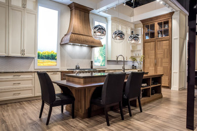Example of a transitional kitchen design in Toronto with white cabinets
