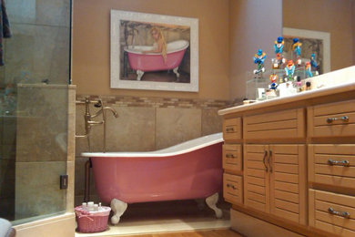 Mid-sized eclectic master claw-foot bathtub photo in Las Vegas with light wood cabinets and a built-in vanity
