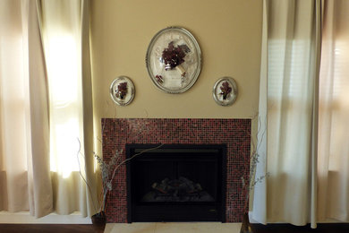 This is an example of a mid-sized traditional formal open concept living room in San Francisco with yellow walls, medium hardwood floors, a standard fireplace, a tile fireplace surround, no tv and brown floor.