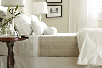 This is an example of a traditional bedroom in Toronto with beige walls and carpet.