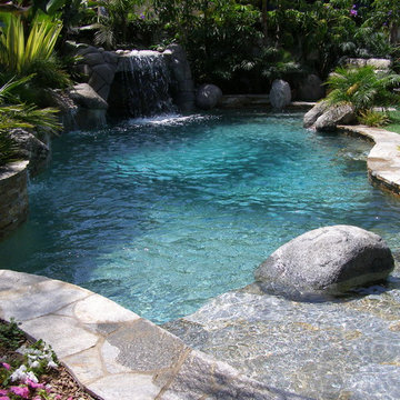 Lagoon style pool with grotto and custom stone work.