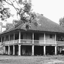 Full wrap around porch, hip roof, dormers, on stilts