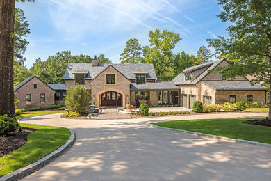 Example of a large transitional two-story exterior home design in Other