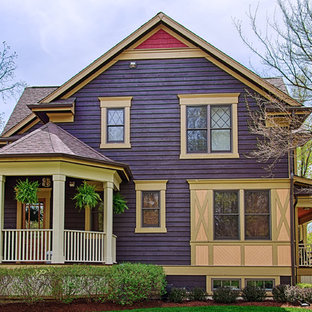 This is an example of a medium sized bohemian two floor exterior in Chicago with wood cladding and a purple house.