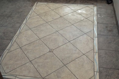 Example of a trendy porcelain tile entryway design in Other