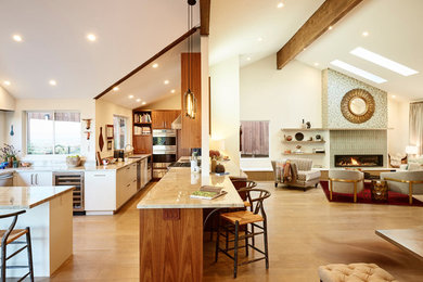 Open concept kitchen - mid-sized contemporary u-shaped medium tone wood floor and brown floor open concept kitchen idea in New York with flat-panel cabinets, medium tone wood cabinets, stainless steel appliances and a peninsula
