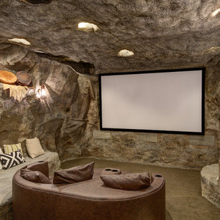 Example of a mountain style enclosed carpeted and gray floor home theater design in Salt Lake City with gray walls and a projector screen