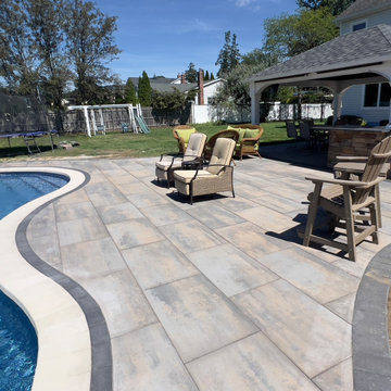 Unilock XL smooth Almond Grove Pool Patio with Travertine Waterfalls - Deer Park