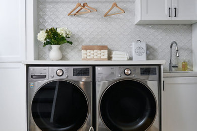 Example of a transitional laundry room design in Toronto