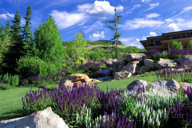 Design ideas for a large traditional front yard full sun xeriscape for summer in Salt Lake City with a retaining wall.