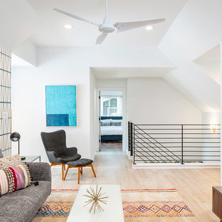 Family room - mid-sized transitional loft-style light wood floor and brown floor family room idea in Austin with multicolored walls, no fireplace and no tv
