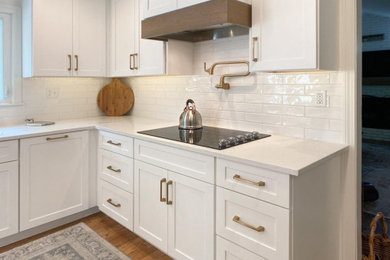 Inspiration for a mid-sized transitional l-shaped eat-in kitchen remodel in Other with shaker cabinets, white cabinets, white backsplash, ceramic backsplash, stainless steel appliances, two islands and white countertops