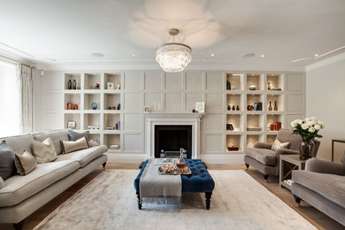 This is an example of a large contemporary formal living room with grey walls and light hardwood floors.
