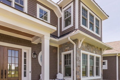 Inspiration for a large craftsman brown three-story wood house exterior remodel in Baltimore with a mixed material roof