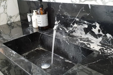 Small contemporary cloakroom in London with open cabinets, a two-piece toilet, white tiles, marble tiles, white walls, marble flooring, a built-in sink, marble worktops and white floors.